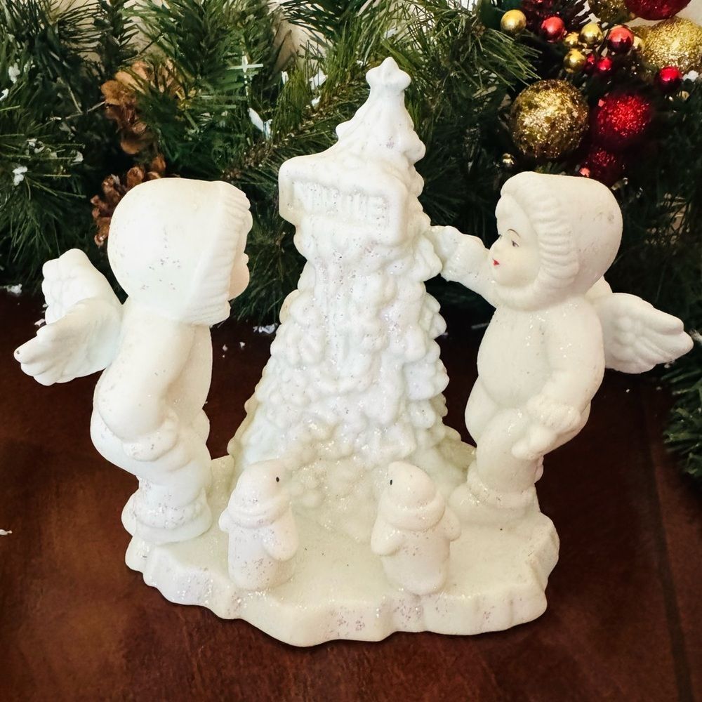 Ceramic Angels Decorating Tree With Baby Penguins